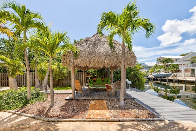 surrounding community featuring a water view, a gazebo, and a boat dock