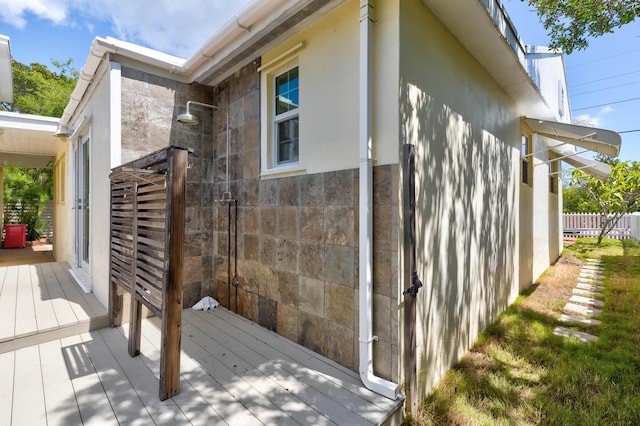 view of property exterior with a wooden deck