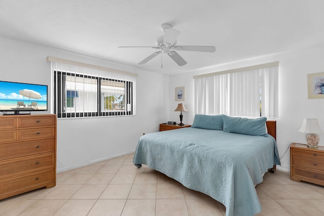 511 9th St, Key Colony, FL 33051 - bedroom featuring light tile patterned floors, a ceiling fan, and baseboards