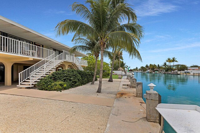 511 9th St, Key Colony, FL 33051 - view of community featuring stairs and a water view