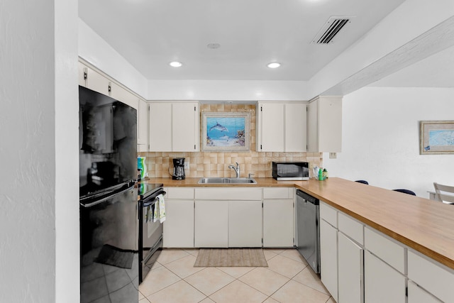511 9th St, Key Colony, FL 33051 - kitchen with black appliances, a sink, decorative backsplash, light countertops, and light tile patterned floors