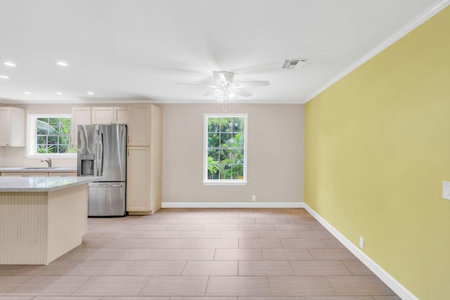 kitchen with stainless steel refrigerator with ice dispenser, ceiling fan, crown molding, and sink