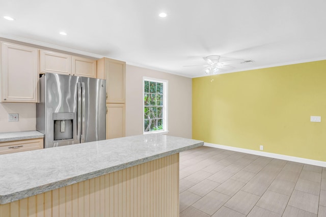 kitchen with stainless steel refrigerator with ice dispenser, light brown cabinetry, crown molding, ceiling fan, and light stone countertops