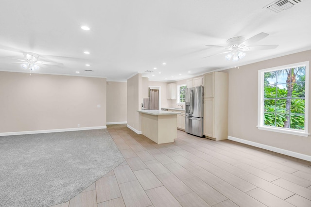 unfurnished living room featuring plenty of natural light, ornamental molding, and ceiling fan