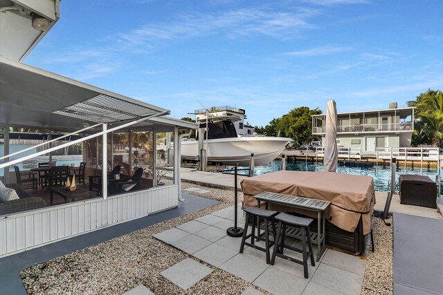 view of patio featuring a water view and a boat dock