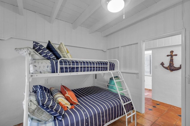 tiled bedroom with beam ceiling