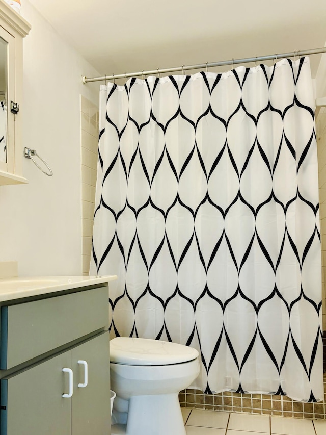 bathroom featuring vanity, a shower with curtain, tile patterned floors, and toilet