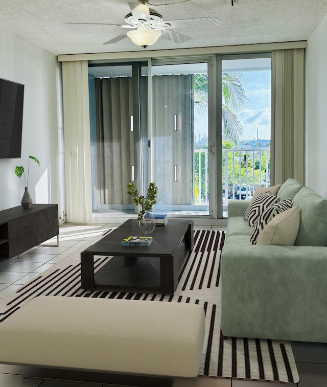 tiled living room with ceiling fan and a textured ceiling