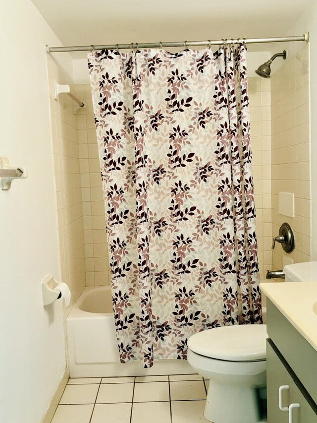 full bathroom featuring tile patterned flooring, vanity, toilet, and shower / tub combo with curtain