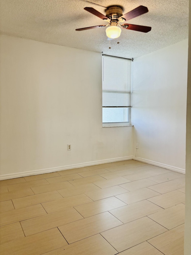 unfurnished room featuring ceiling fan, a textured ceiling, and light wood-type flooring