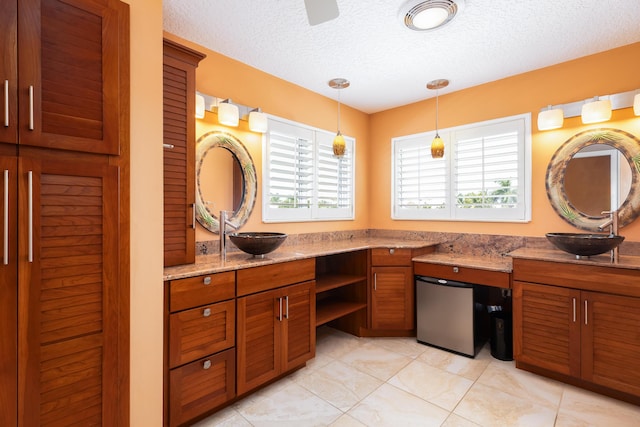 bathroom with vanity, tile patterned flooring, and a textured ceiling