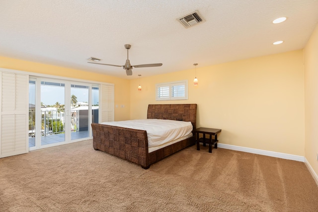 carpeted bedroom featuring ceiling fan, a textured ceiling, and access to outside