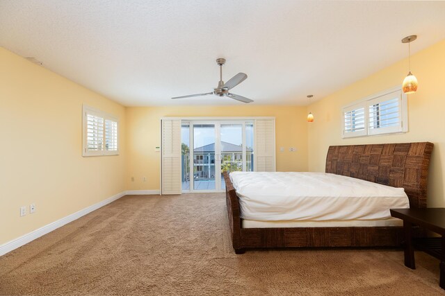 bedroom featuring access to exterior, ceiling fan, and carpet