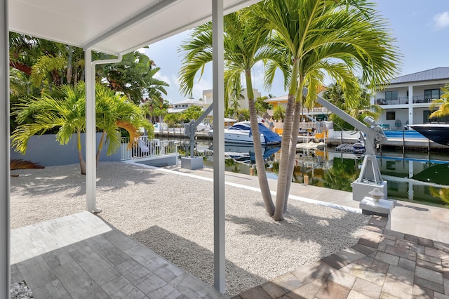 view of patio featuring a water view and a boat dock