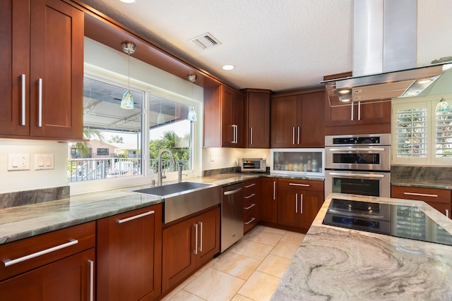 kitchen with sink, light stone counters, a textured ceiling, island exhaust hood, and stainless steel appliances