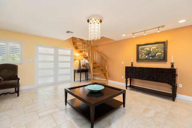 living room featuring track lighting and a notable chandelier