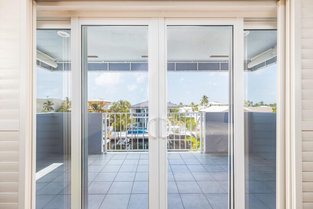 doorway with french doors and light tile patterned floors