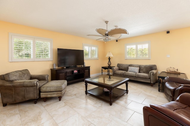 living room with ceiling fan and a wealth of natural light