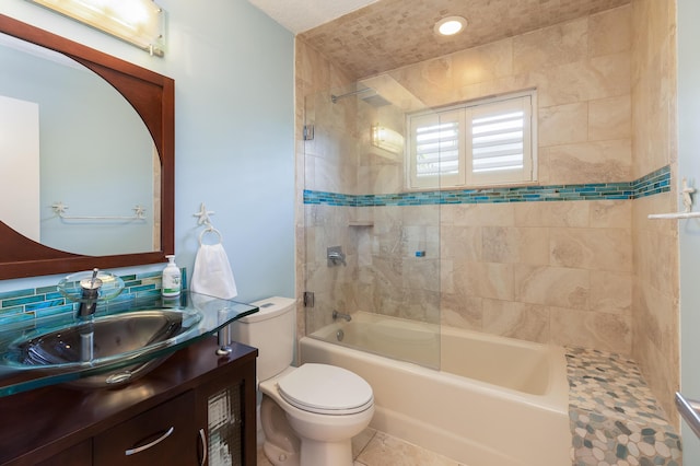 full bathroom with tile patterned floors, vanity, toilet, and tiled shower / bath combo