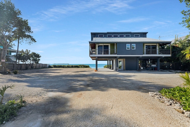 view of front of property featuring a water view and a carport