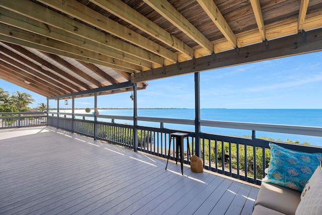 wooden terrace featuring a water view