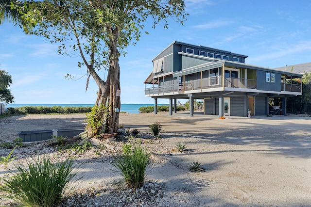 exterior space featuring a carport, a water view, and a sunroom