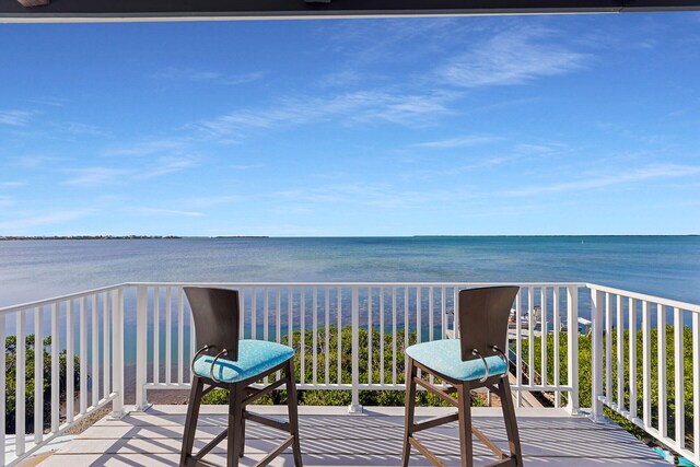 wooden deck featuring a water view