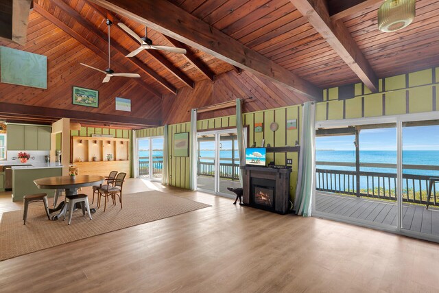 unfurnished dining area featuring wood ceiling, high vaulted ceiling, light hardwood / wood-style floors, beamed ceiling, and wood walls