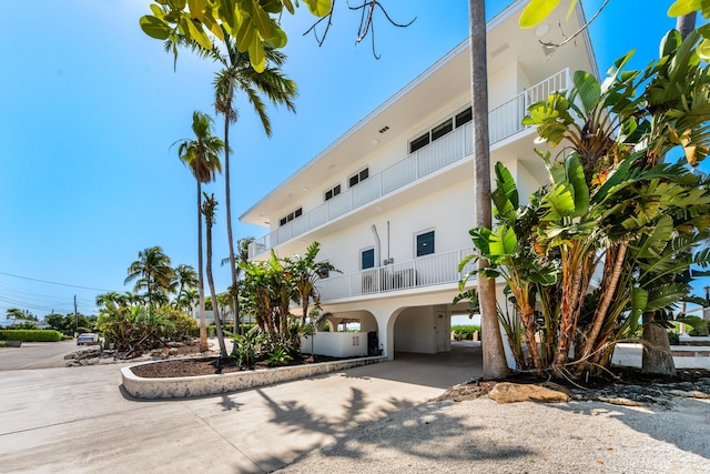 228 W Seaview Cir, Duck, FL 33050 - view of building exterior featuring a carport and driveway