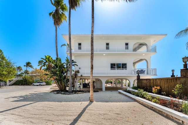 228 W Seaview Cir, Duck, FL 33050 - view of front of home featuring a carport, a balcony, stucco siding, and driveway