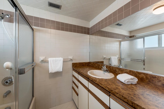 228 W Seaview Cir, Duck, FL 33050 - full bath with tile walls, vanity, and combined bath / shower with glass door