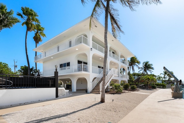 228 W Seaview Cir, Duck, FL 33050 - view of building exterior featuring a carport and stairway