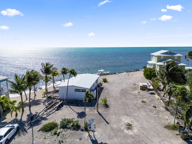 birds eye view of property featuring a water view and a view of the beach