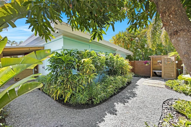 view of side of home featuring fence