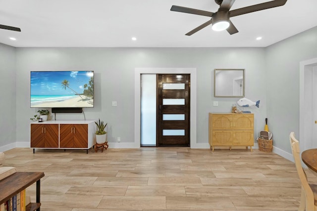 foyer entrance with light wood-style floors, ceiling fan, baseboards, and recessed lighting