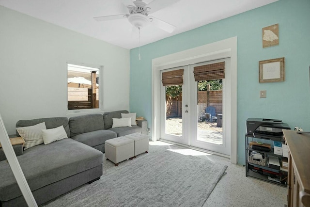 living area featuring a healthy amount of sunlight, ceiling fan, and french doors