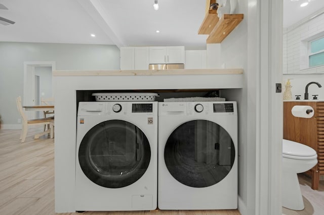 washroom featuring laundry area, washer and clothes dryer, recessed lighting, and light wood-style floors