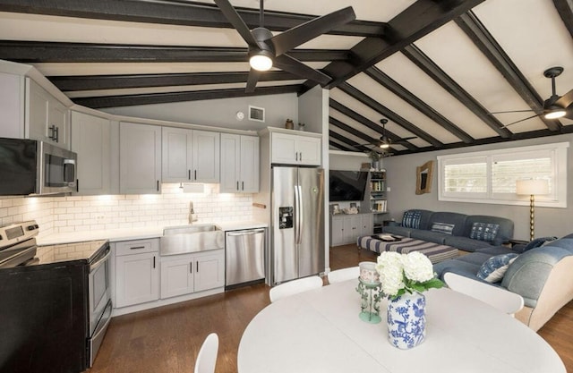 kitchen with stainless steel appliances, white cabinetry, sink, and ceiling fan