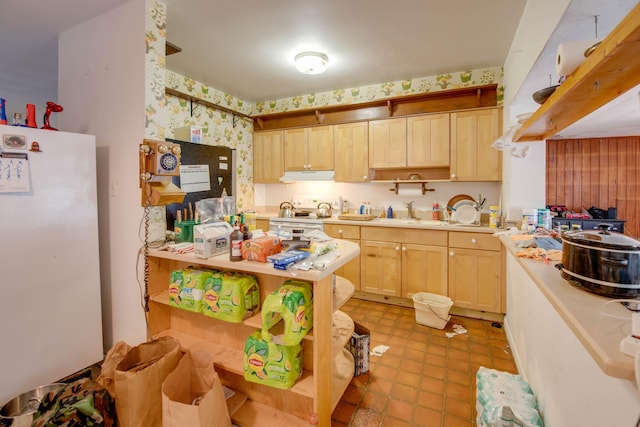 3746 Paula Ave, Key West, FL 33040 - kitchen with under cabinet range hood, wallpapered walls, light countertops, white appliances, and open shelves