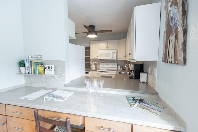 kitchen featuring sink, white appliances, ceiling fan, built in desk, and decorative backsplash