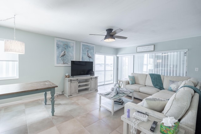 tiled living room featuring ceiling fan