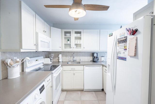 kitchen featuring sink, white appliances, and white cabinets