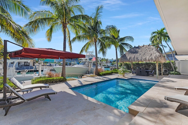 view of swimming pool with a gazebo and a water view