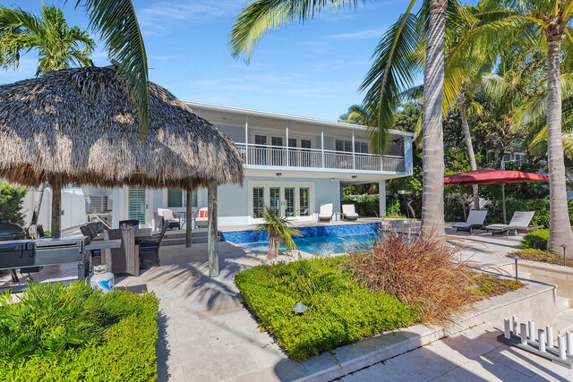 view of pool with french doors and a patio area