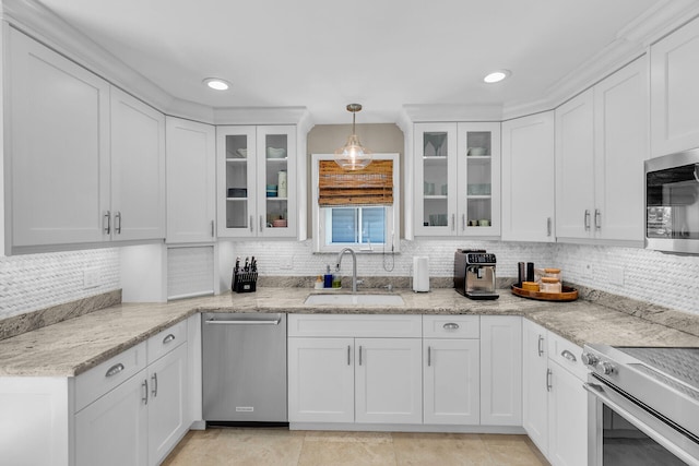 kitchen featuring sink, hanging light fixtures, white cabinets, and appliances with stainless steel finishes