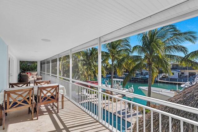 sunroom / solarium featuring a water view