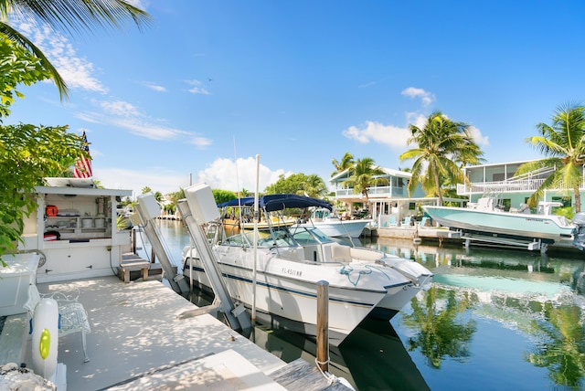 dock area with a water view and boat lift