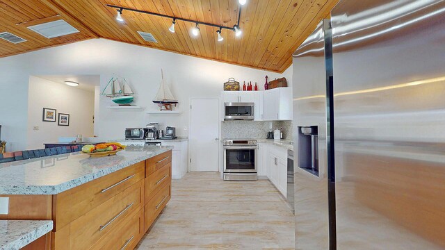 playroom featuring hardwood / wood-style floors, vaulted ceiling, and a textured ceiling