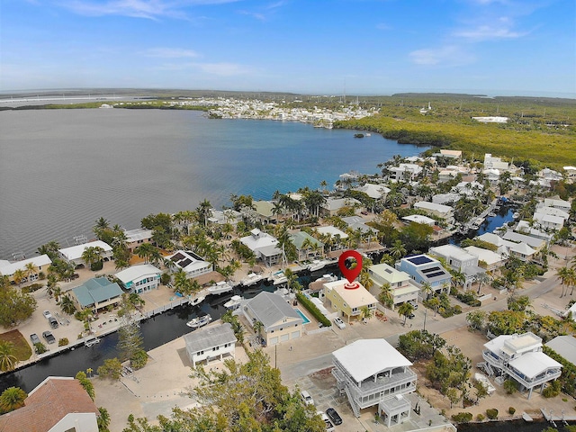 drone / aerial view featuring a water view and a residential view