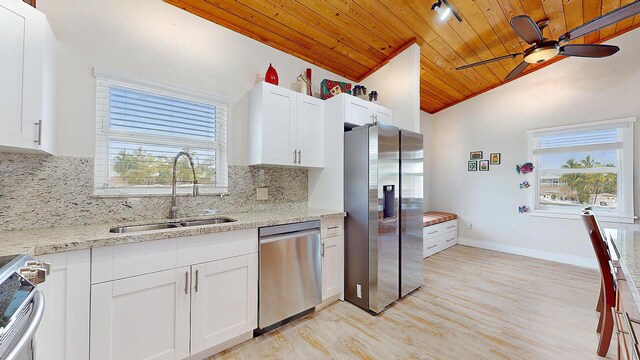 kitchen with wood ceiling, light hardwood / wood-style flooring, ceiling fan, a center island, and light stone counters